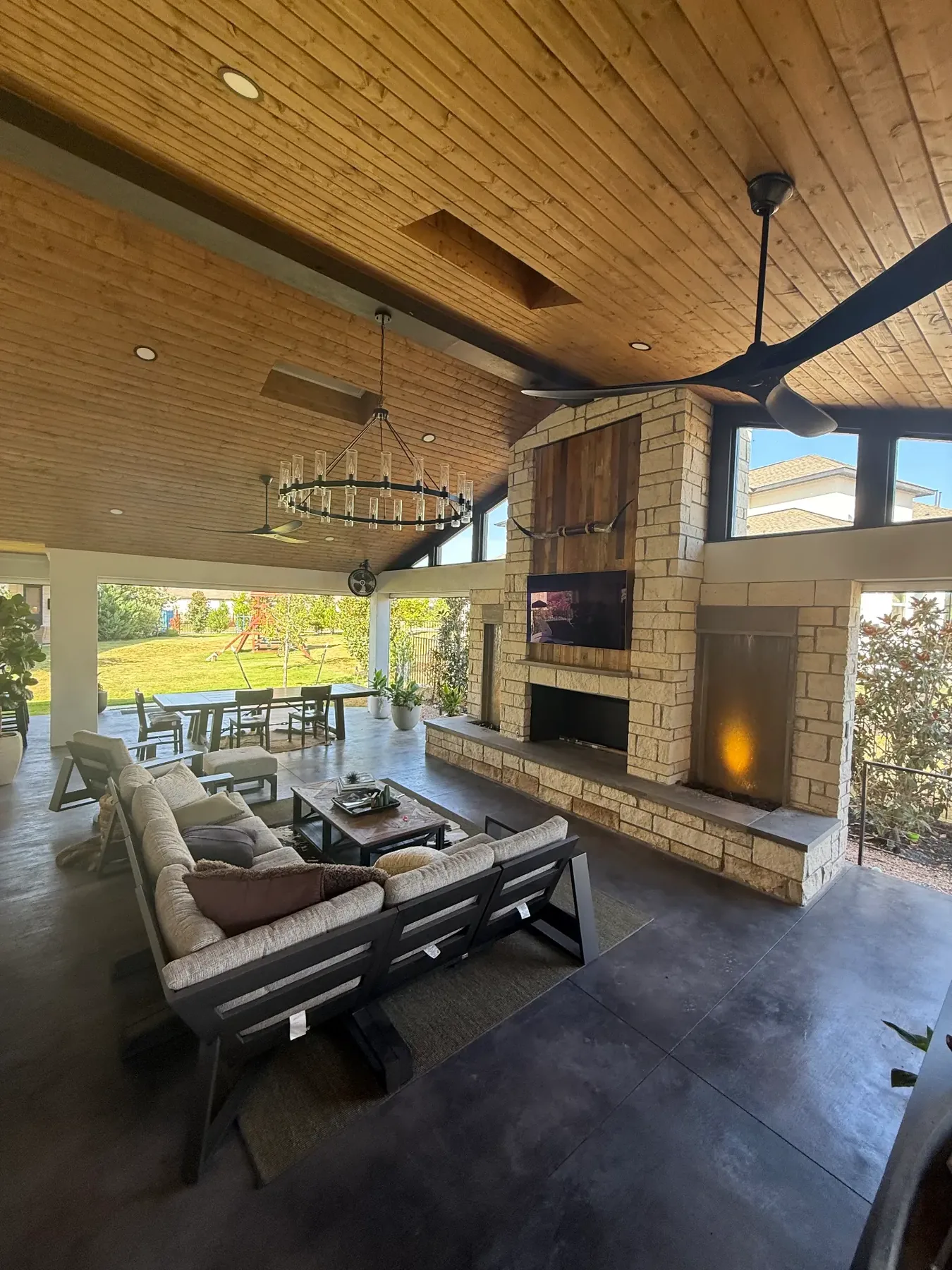 Vaulted covered living space with stone fireplace built by TWT